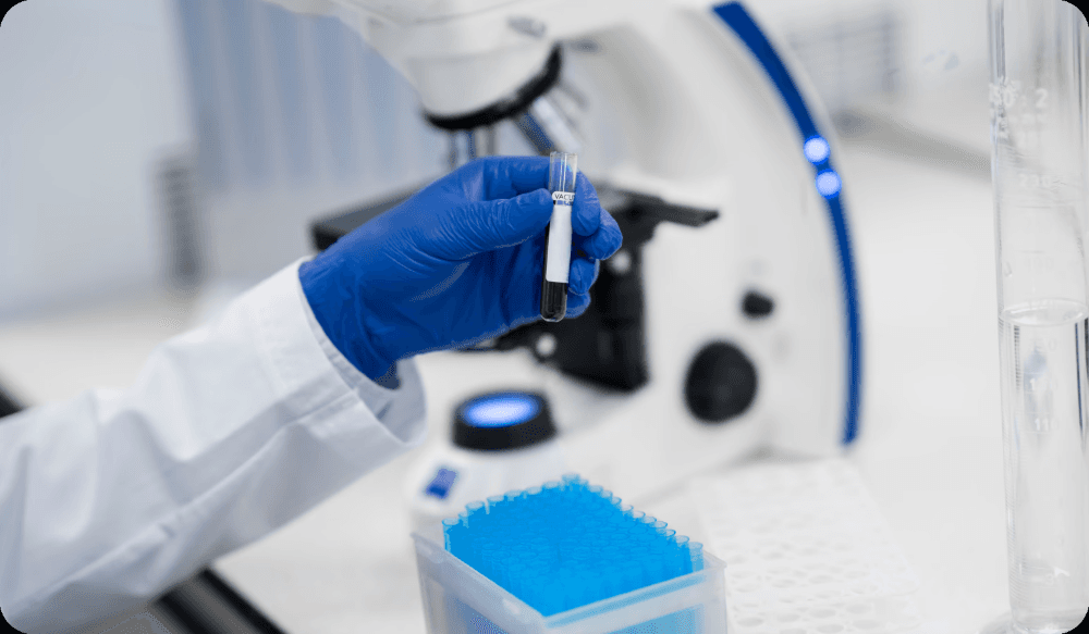 Scientist pipetting samples into a microplate